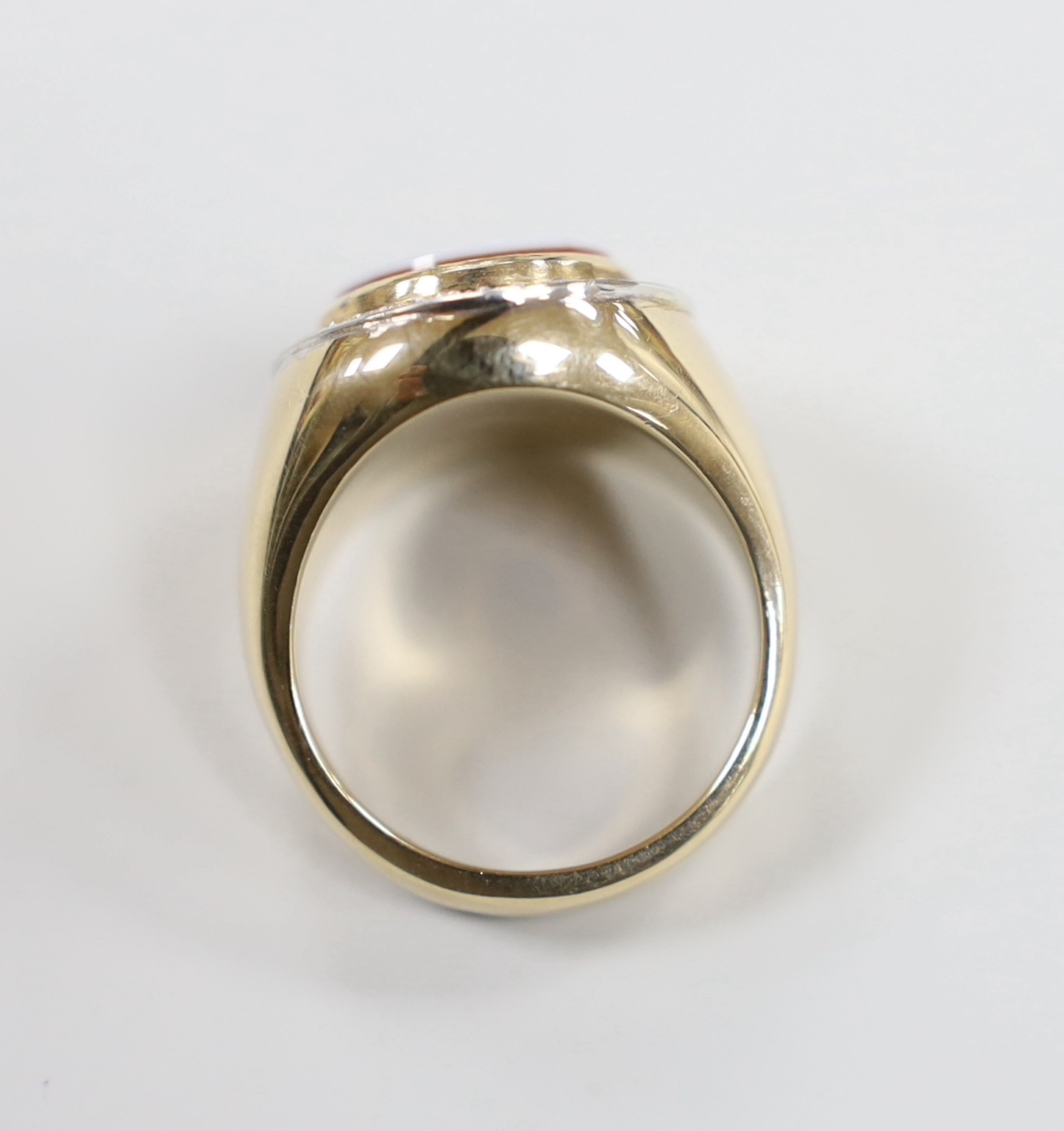 A modern 9ct gold and white carnelian set oval dress ring, with diamond chip set border, size R, gross weight 17.1 grams.